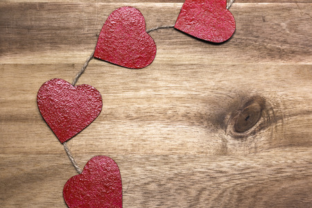 Red hearts on wooden background. Valentine's day greeting card with place for text.の写真素材