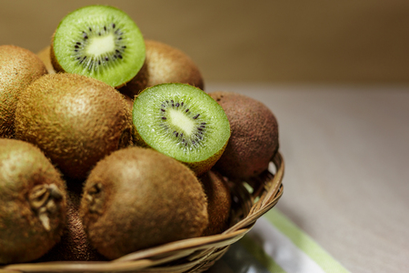 Ripe kiwi fruits in a basket. Healthy nutrition concept.の写真素材