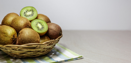 Ripe kiwi fruits in a basket. Healthy nutrition concept.の写真素材
