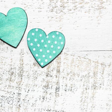Two wooden hearts on white rustic