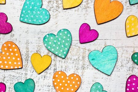 Colorful hearts on white wooden background. Valentines day concept. Flat lay, top view, copy space.の写真素材