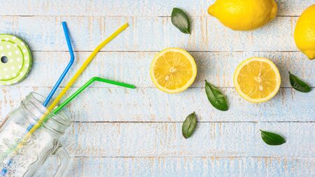 Flat lay composition with smoothie jar and fresh lemons on light blue wooden background. Copy space, top view.の写真素材