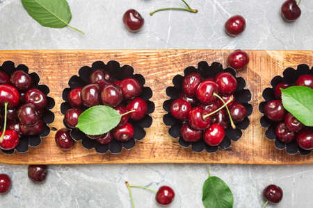 Flat lay composition with sweet cherries on marble table, space for text.の写真素材