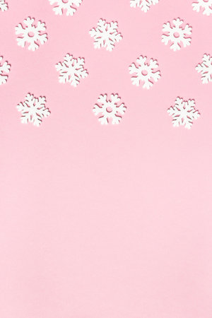 Christmas composition made of snowflakes on pastel pink background. Winter concept. Flat lay, top view, copy space.の写真素材