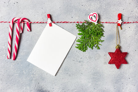 Christmas composition. Christmas ornaments and evergreen tree branches on gray stone background....