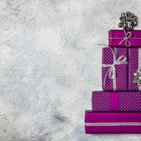 Christmas tree made of purple gifts boxes on greyの写真素材