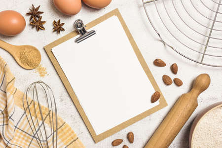 Ingredients and utensils for baking cakes with blank sheet for recipes, flat lay. Baking or cooking concept.の写真素材