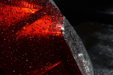 Rain drops on red headlight of a carの写真素材