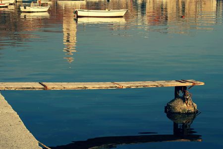 Old wooden dock in sunset on autumn day.