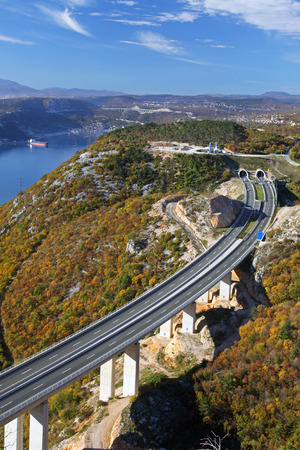 Highway bridge and tunnel through autumn scenery, Croatia.の写真素材