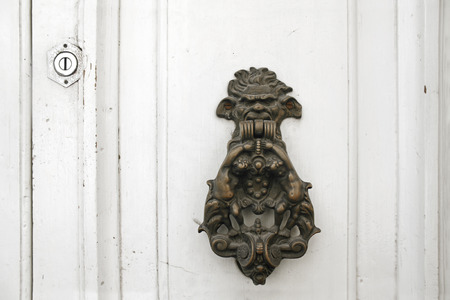 Brass knocker on a white door in Malta.の写真素材