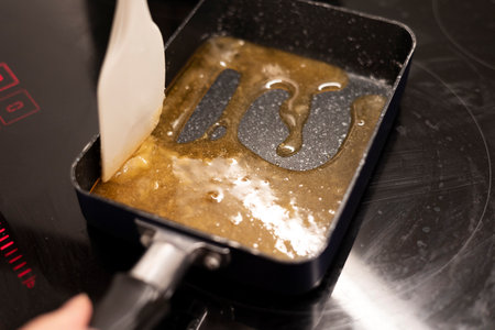 Melt a sugar sauce in a frying pan, sugar caramelizingの写真素材