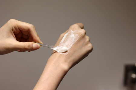 Applying cosmetic cream on the hands with spatulaの写真素材