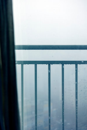A fog-shrouded city view through the banisterの写真素材