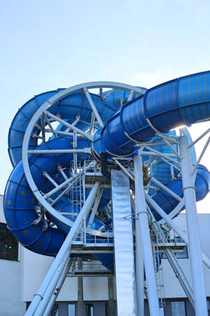 Water slide in the water park from the outside. Design of a rotating slide in the pool. Aquapark in...