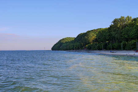 View from the Baltic Sea on the breakwater and the Orlowski cliff in Gdynia. The steep seashore of Kepa Redlowska in Gdyniaの写真素材