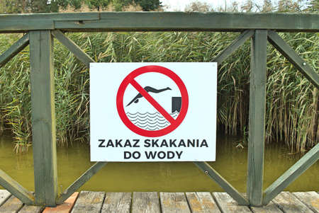Warning sign "No jumping into the water"の写真素材