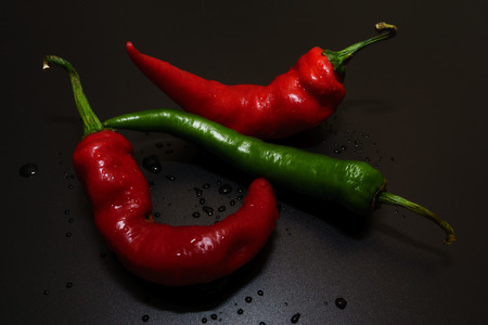 Red and Green Hot Chilli peppers with isolated by black background.