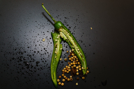 Green Hot Chilli peppers with isolated by black background.の写真素材