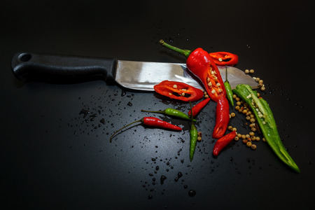 Red and Green Hot Chilli peppers with isolated by black background.の写真素材