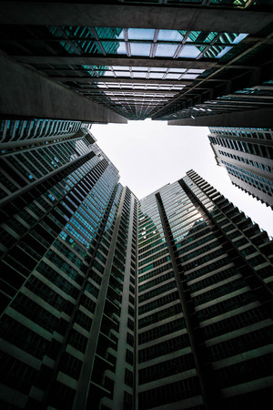 Low angle shot of modern glass city buildings with clear sky background.の写真素材