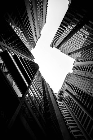 Low angle shot of modern glass city buildings with clear sky background.の写真素材