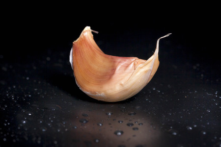 Clove of garlic isolated with black backgroundの写真素材