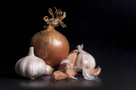 Onion and Fragrant garlic isolated with black backgroundの写真素材
