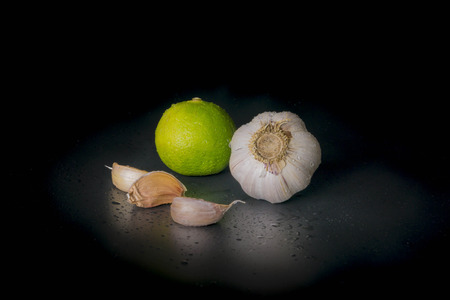 Garlic and Lime on Black background.の写真素材