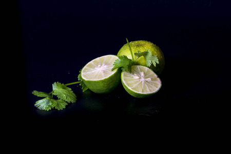 Lime decorated parsley leaves on black background