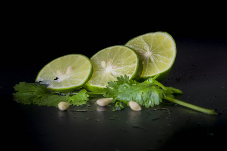 Lime decorated parsley leaves on black backgroundの写真素材