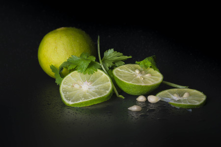 Lime decorated parsley leaves on black backgroundの写真素材