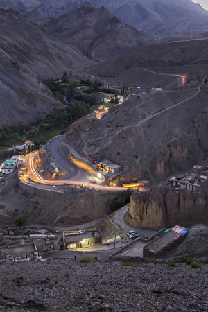 Light trails moving vehicles on winding road at Lamayuru Sham Valley Leh India.の写真素材