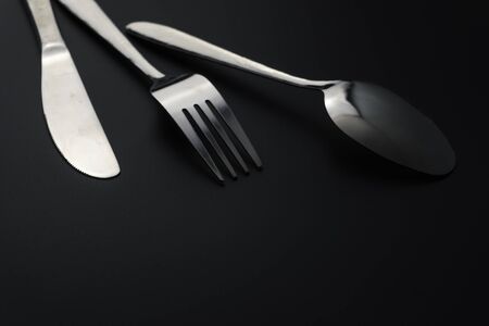 Fork and spoon on dark background, Restaurant concept. soft focus in the middle.の写真素材