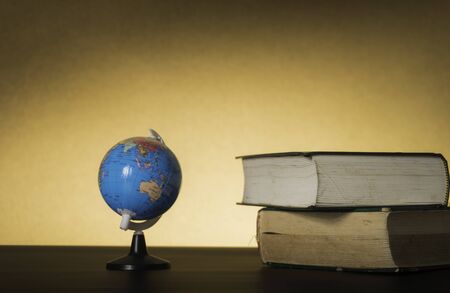 Symbolic hard study is powerful to succeed, concept with book and alarm clock. Time in business and...