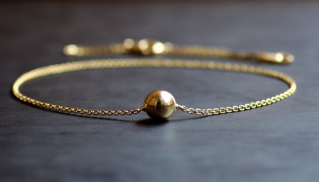 Shiny gold necklace with gemstone sphere and metallic chain decoration generated by artificial intelligenceの素材