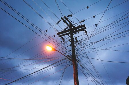 Electric pole with dark blue skyの写真素材