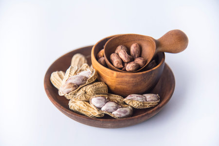 Tiger Peanuts in  wooden bowls a collection of whole peanuts in their shells and a few without...