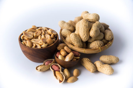 Peanuts in basket a collection of whole peanuts in their shells and a few without shells,healthy snacking concept with peanuts rich in protein, isolated on white background.の写真素材