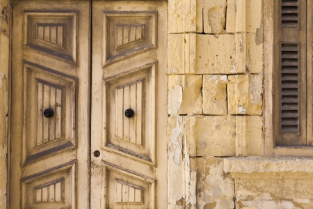 Old wooden doors and stone work on traditional built house in Maltaの写真素材