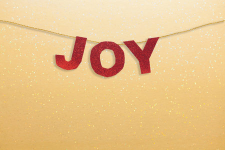 Joy Christmas Decoration red glitter letters on golden glittery backgroundの写真素材