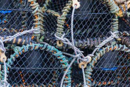 Stacked fishermans  lobster pots close up Folkestone harbour, Kent, UK