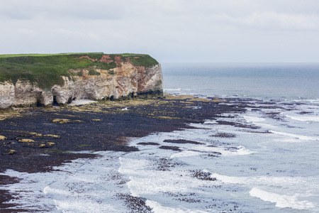 Cliffs at Flamborough Head overlooking the North Sea on a dull and cloudy dayの写真素材