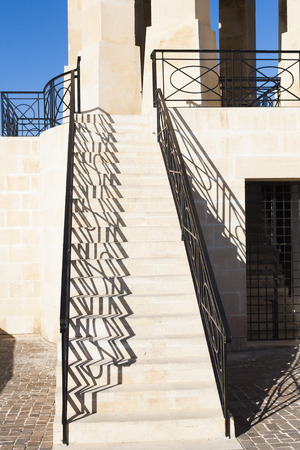 Steps with railings and shadows leading to Maltese war memorial in commemmoration of battle for maltaのeditorial素材
