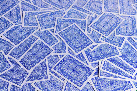 Blue and white playing card background for concepts of gambling and addiction