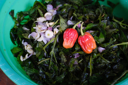 Two Red Katokkon Pepper Mix with Miana Vegetable and Red Onion. Torajan typical food.