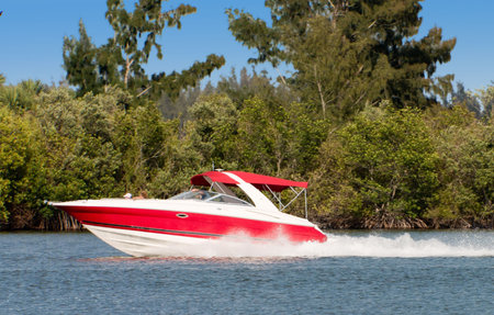 Red/White boat traveling across water