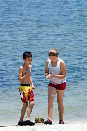 Brother and sister playing on beach