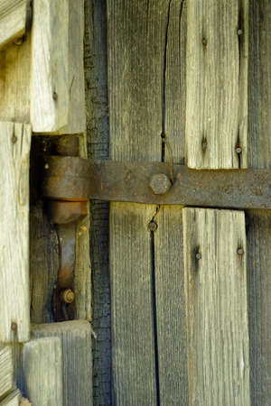 Old doorbell made of wood. The door of an old cellar.の写真素材