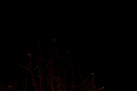 the lights from the bonfire fly up at night.